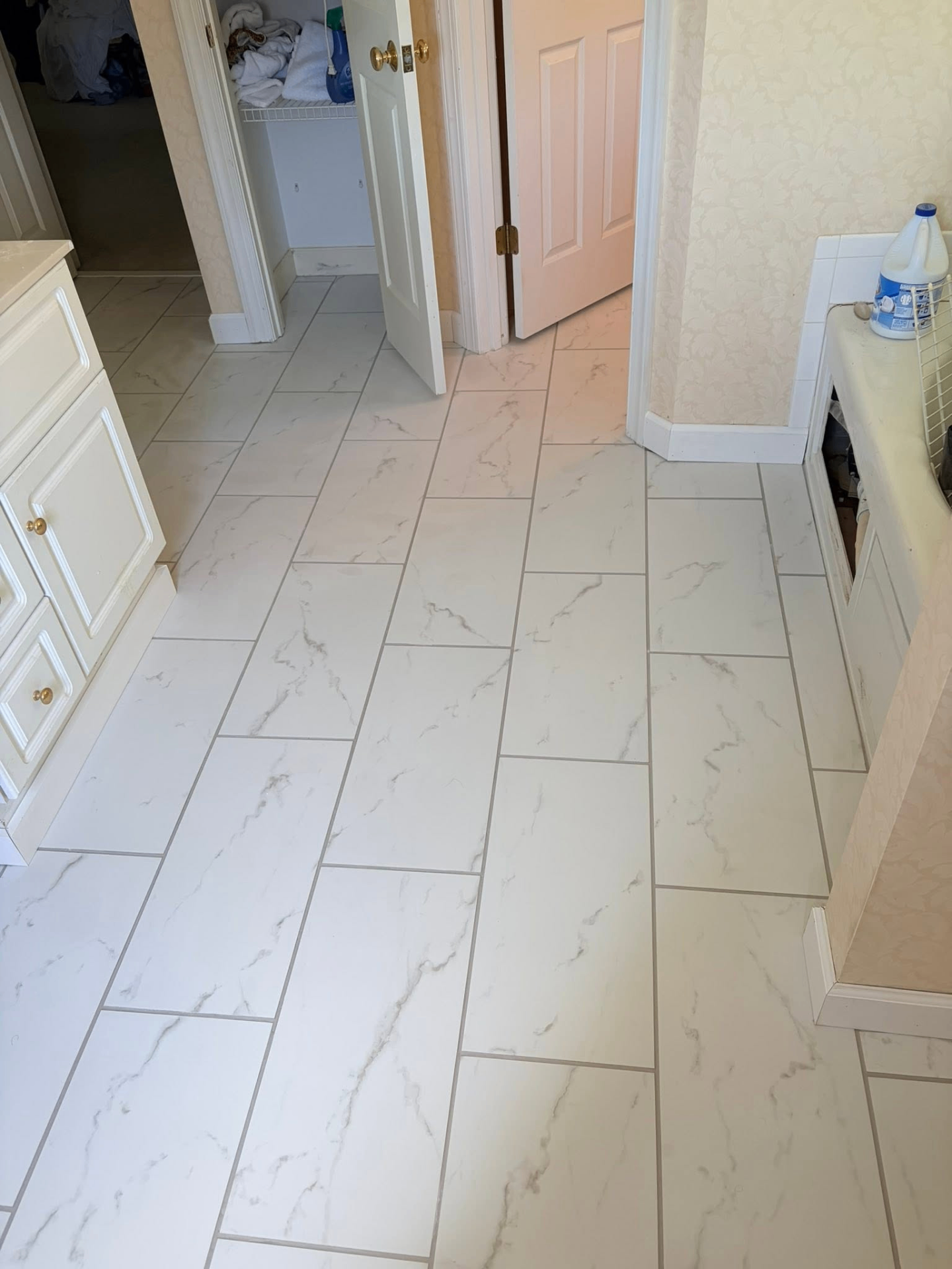 Marble-look porcelain tile floor in a renovated bathroom